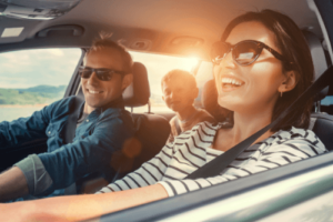 Your Ultimate Pre-Trip Maintenance Checklist with C's Autohaus in Centerville, OH. image of happy family driving on a roadtrip with the sun shining on their faces