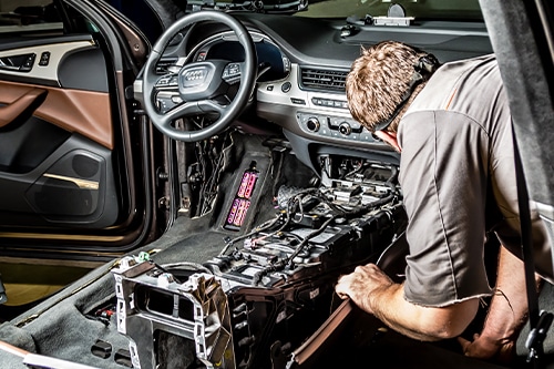 A mechanic repairs an Audi’s electrical components. Concept image of Audi repair at C’s Autohaus in Centerville, OH.