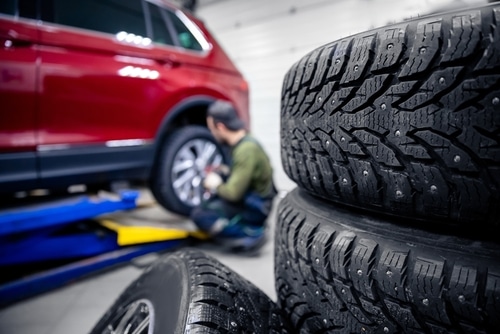 a car specialist in Centerville busy checking and replacing tire for winter | C’s Autohaus