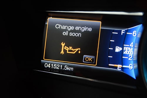 European Car Maintenance | Regular Oil Change Importance | C’s Autohaus. Image of modern car dashboard reading change oil soon.