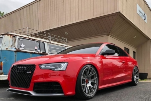 Audi Maintenance Services in Centerville, OH at C’s AutoHaus. Image of a red Audi sedan parked outside C’s AutoHaus after undergoing preventative maintenance.