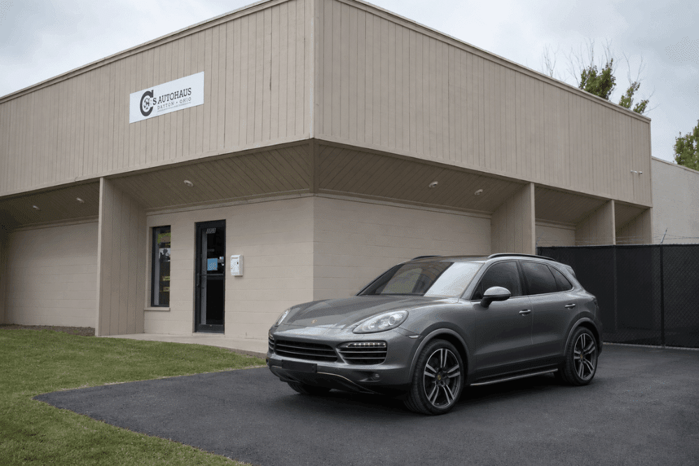 Porsche Cayenne, auto repair in Centerville, OH at C’s Autohaus. Image of the C's Autohaus facility with a Porsche SUV parked outside, highlighting trusted European vehicle service and a commitment to performance and precision.