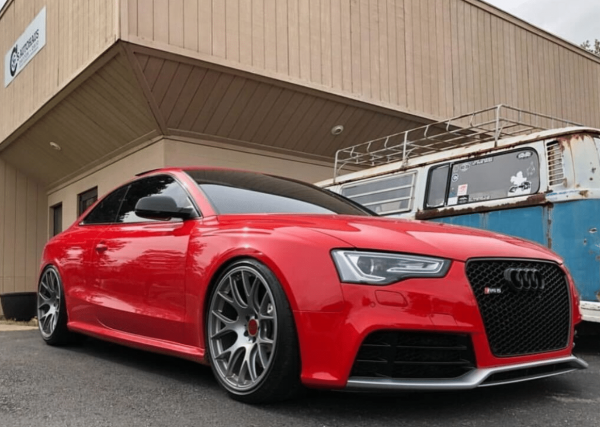 Audi Repair and Maintenance in Centerville, OH by C's Autohaus. A sleek, red Audi parked in front of C's Autohaus, showcasing their expertise in servicing and maintaining high-performance vehicles.